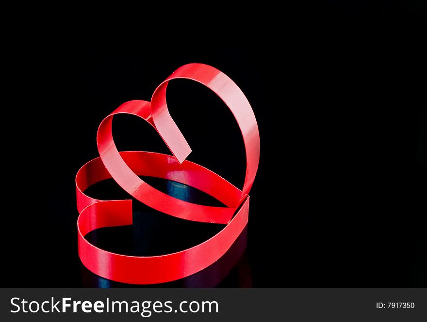 Two hearts with center spot light, on black  background. Two hearts with center spot light, on black  background.