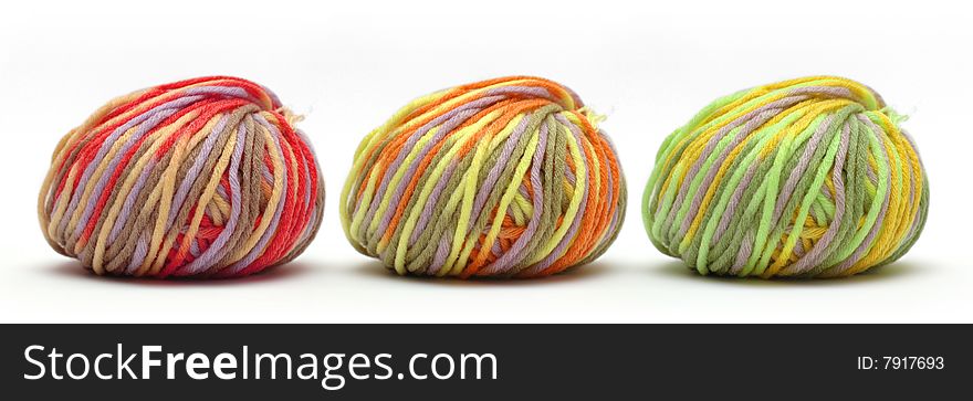 Tree bales of colorful yarn isolated over white