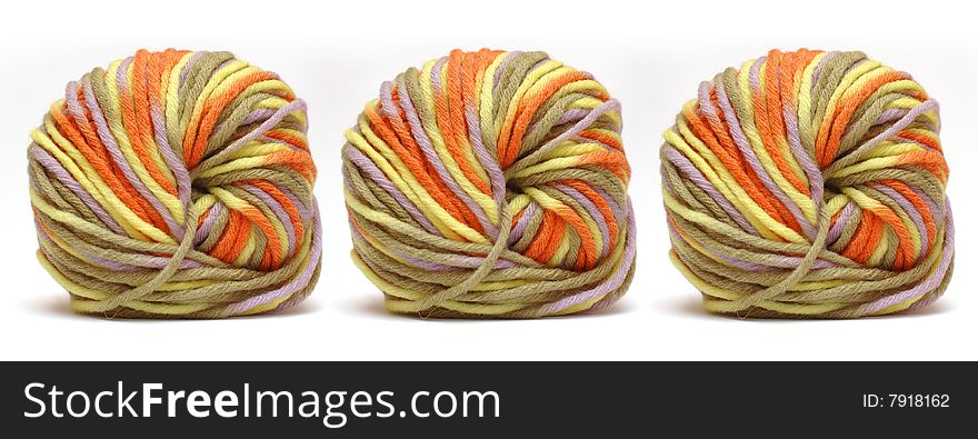 Tree bales of colorful yarn isolated over white