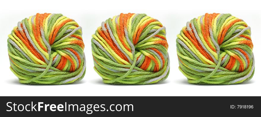 Tree bales of colorful yarn isolated over white
