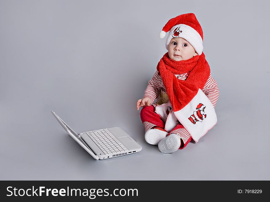 Baby Santa Claus With White Laptop