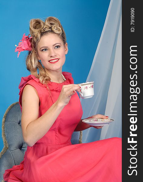 Cute attractive retro girl in red dress with tea cup. Cute attractive retro girl in red dress with tea cup