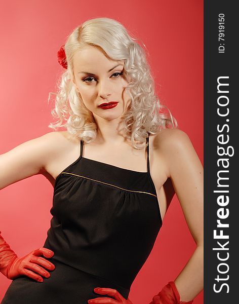 Attractive blond girl in authentic fifties style - black dress, red gloves. Attractive blond girl in authentic fifties style - black dress, red gloves