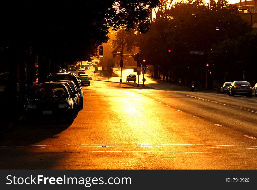 Motorists commute down a street at dusk. Motorists commute down a street at dusk