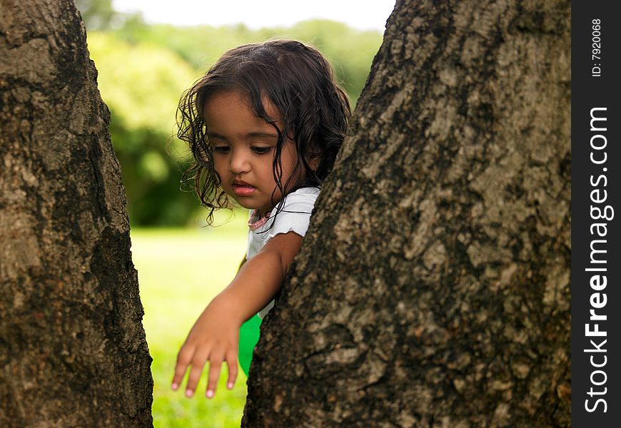 Asian girl in a park hiding