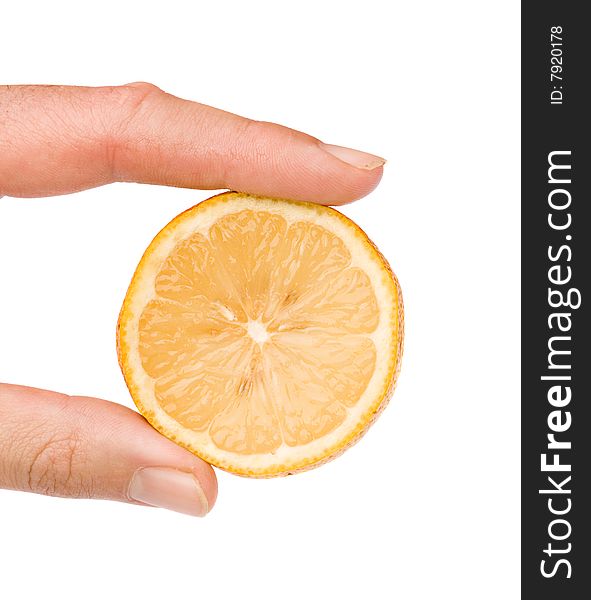 Close up of hand holding a slice of lemon