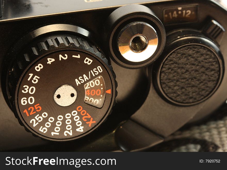 Closeup photo of an old film camera knobs setting and shutter. Closeup photo of an old film camera knobs setting and shutter