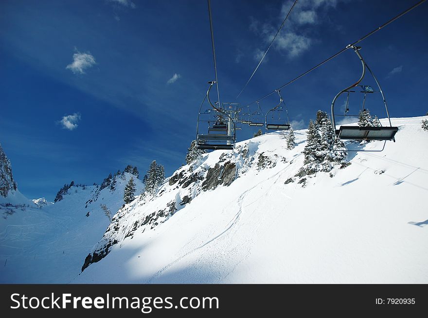 Funicular in the mountains in winter at Alps - white snow and clear sky