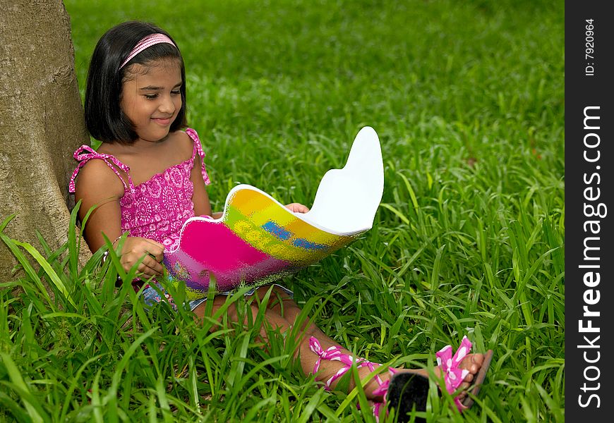 Girl reading a book in the park