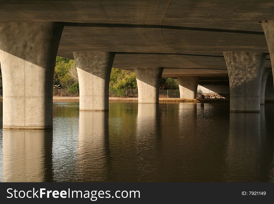 Underside of a bridge with the supports standing in water. Underside of a bridge with the supports standing in water