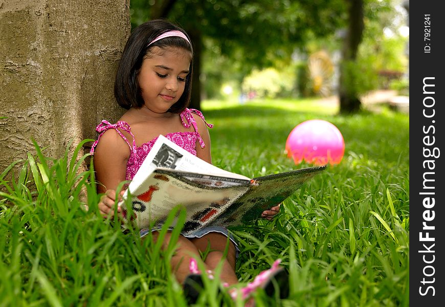 Girl reading a book in the park