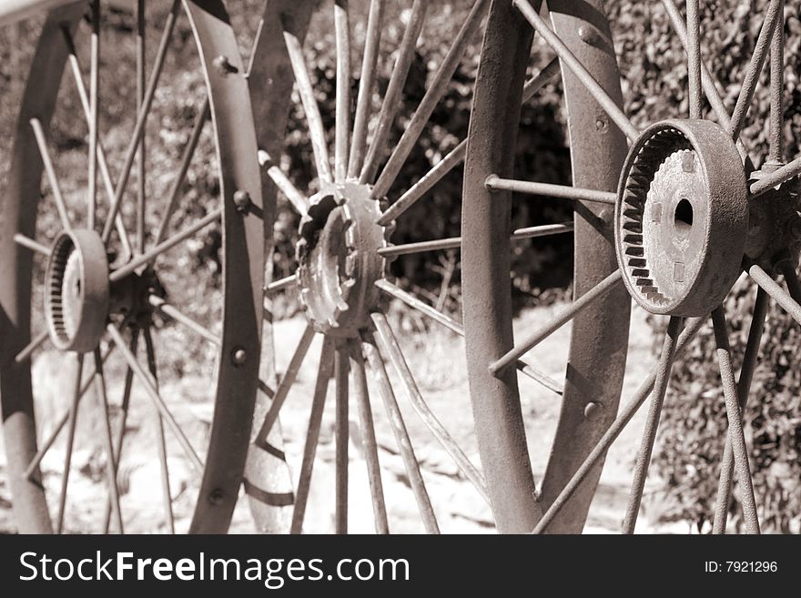 View of three metal wheels in sepia. View of three metal wheels in sepia