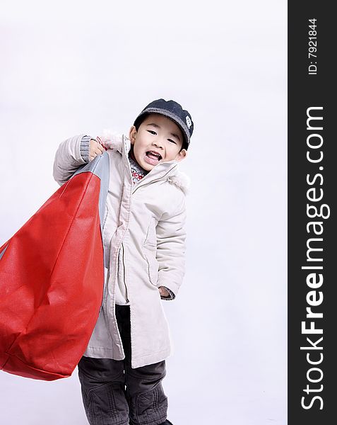 A picture of a pretty chinese boy going shopping carrying a big bag. A picture of a pretty chinese boy going shopping carrying a big bag