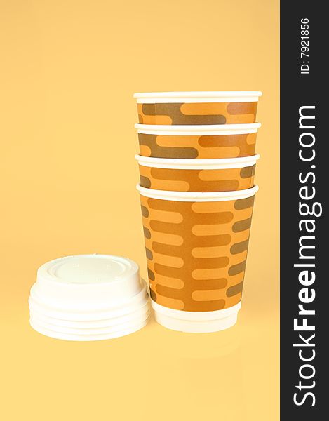 Takeaway coffee cups isolated against an orange background