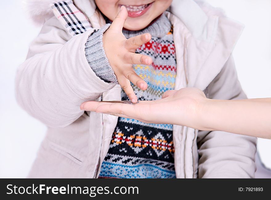 A picture of a little chinese boy playing happily with coins. A picture of a little chinese boy playing happily with coins