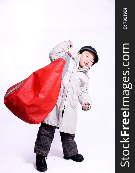 A picture of a pretty chinese boy going shopping carrying a big bag. A picture of a pretty chinese boy going shopping carrying a big bag