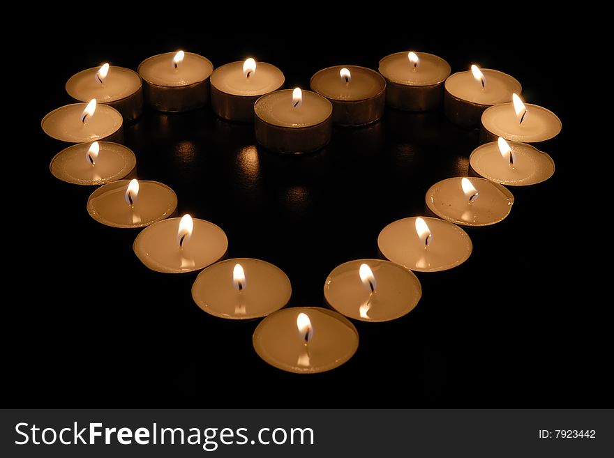 Tea light candles arranged in a heart shape. Tea light candles arranged in a heart shape.