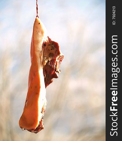 Marinated pork outdoors under the sun to dry