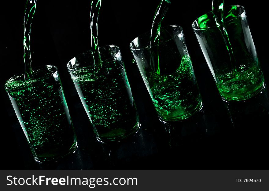 Glass with drink on a black background
