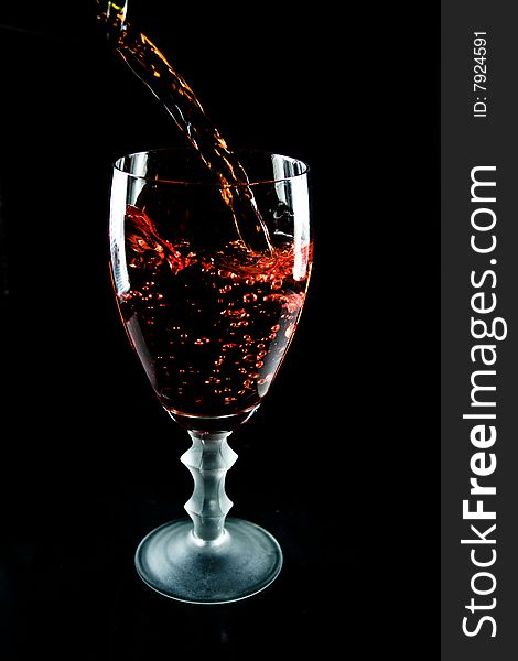 Glass of wine on a black background