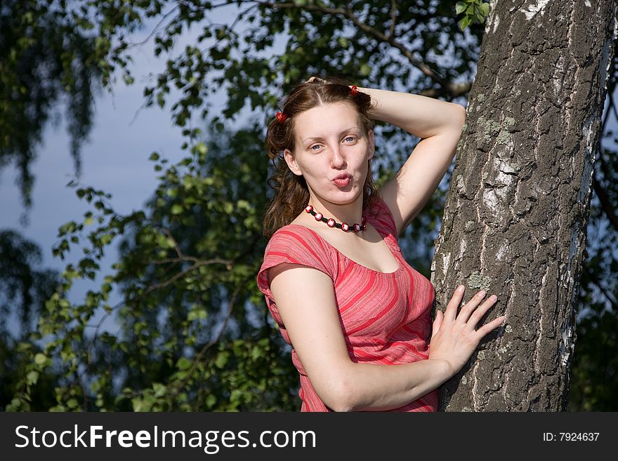 Outdoor portrait of 20-25 years woman near tree, birch