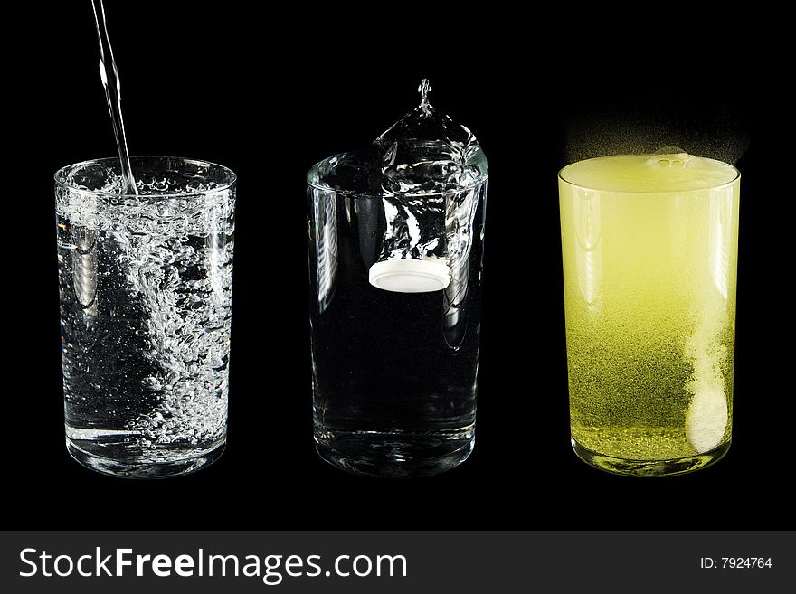 Glasses with water and a tablet. Isolated on a black background