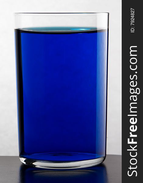Glass with drink blue color. Glass with drink blue color