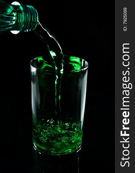Glass with drink on a black background