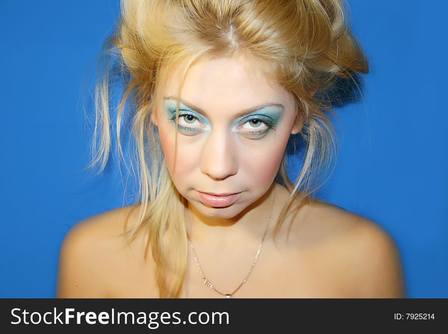 The young beautiful girl on a dark blue background. The young beautiful girl on a dark blue background