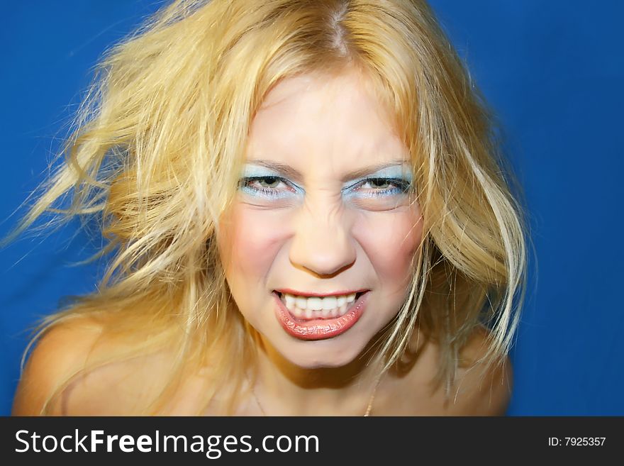 The young beautiful girl on a dark blue background. The young beautiful girl on a dark blue background