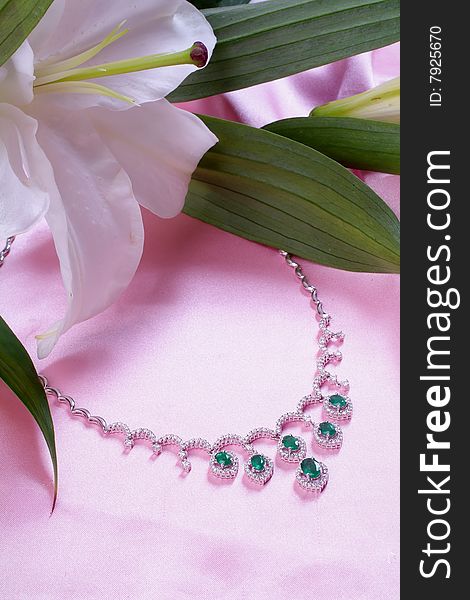 Emerald necklace from white gold and a lily. Emerald necklace from white gold and a lily