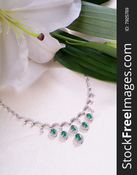 Emerald necklace from white gold and a lily. Emerald necklace from white gold and a lily