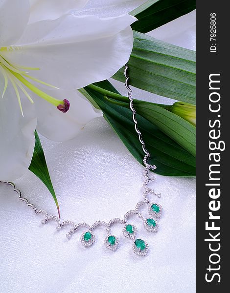 Emerald necklace from white gold and a lily. Emerald necklace from white gold and a lily