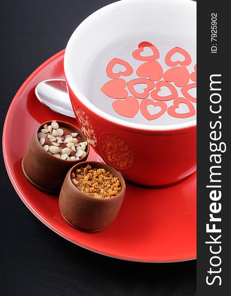 Coffee c up with chocolate candies and heart shape decoration. Coffee c up with chocolate candies and heart shape decoration