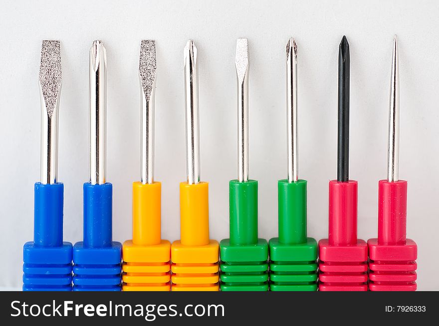 8 colorful screwdrivers on a white background