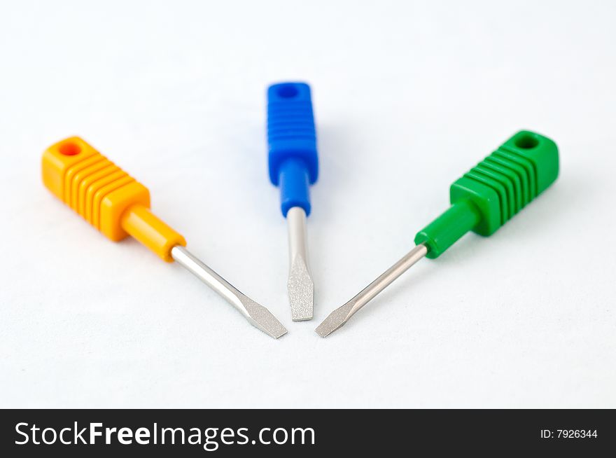 3 colorful minus-type screwdrivers on a white background. 3 colorful minus-type screwdrivers on a white background