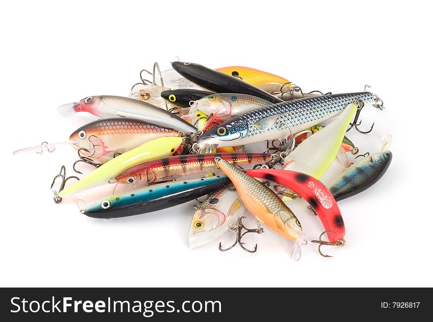 Disordered fishing lures on white background