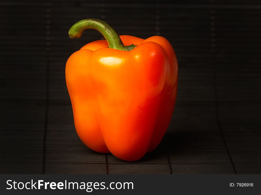 Red pepper on black background