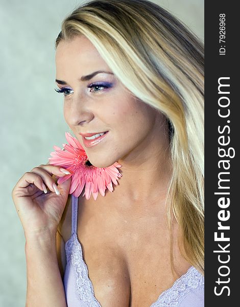 Blond girl with chrysanthemum in studio shot