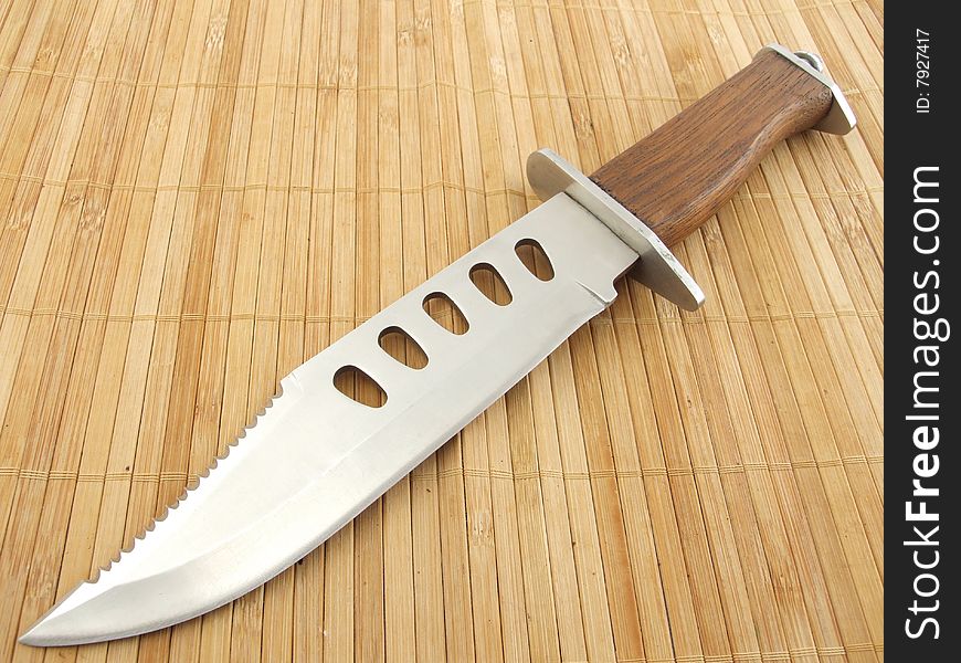 Hunting knife on wood background