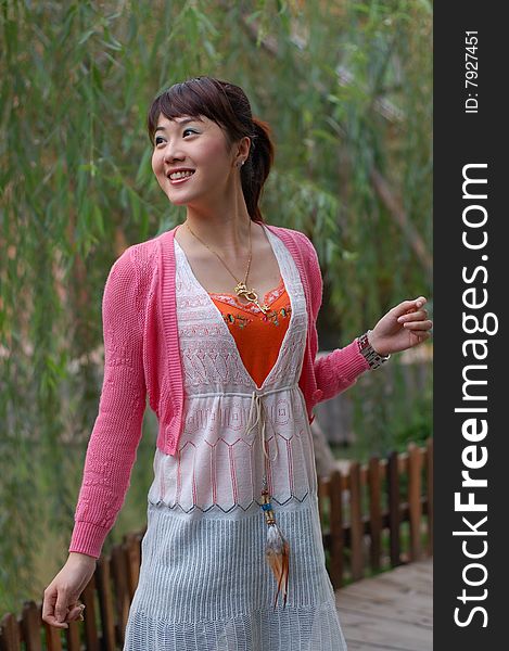 A  beautiful Young girl  standing on the wooden bridge ,from china. A  beautiful Young girl  standing on the wooden bridge ,from china