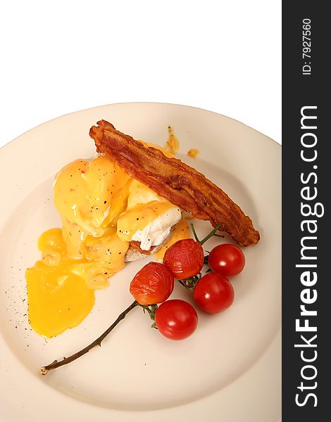 Tasty egg breakfast cooked to perfection with bacon and red tomatoes. Tasty egg breakfast cooked to perfection with bacon and red tomatoes