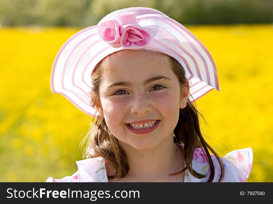 Girl Smiling in Front of Flowers