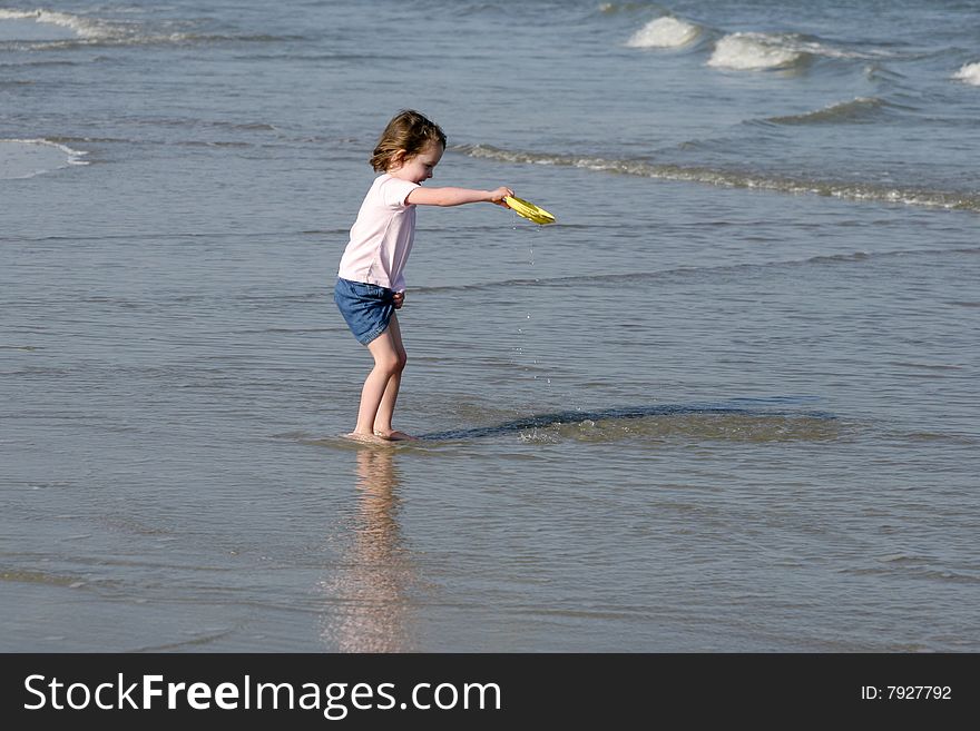 Little girl getting wet and playing in surf. Little girl getting wet and playing in surf