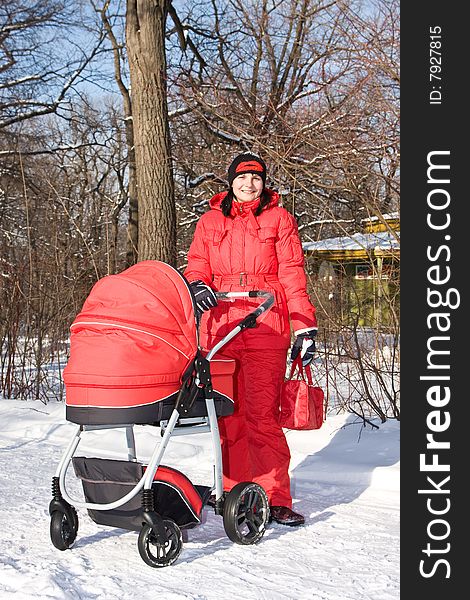 Young woman in red with red baby carriage.