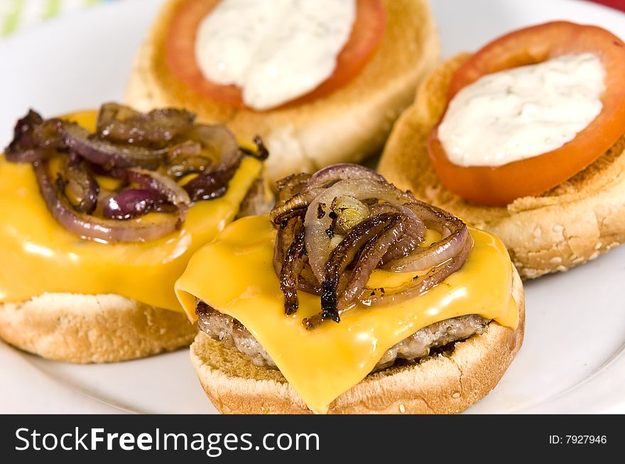 Cheeseburger with fried onions tomato and white sauce. Cheeseburger with fried onions tomato and white sauce