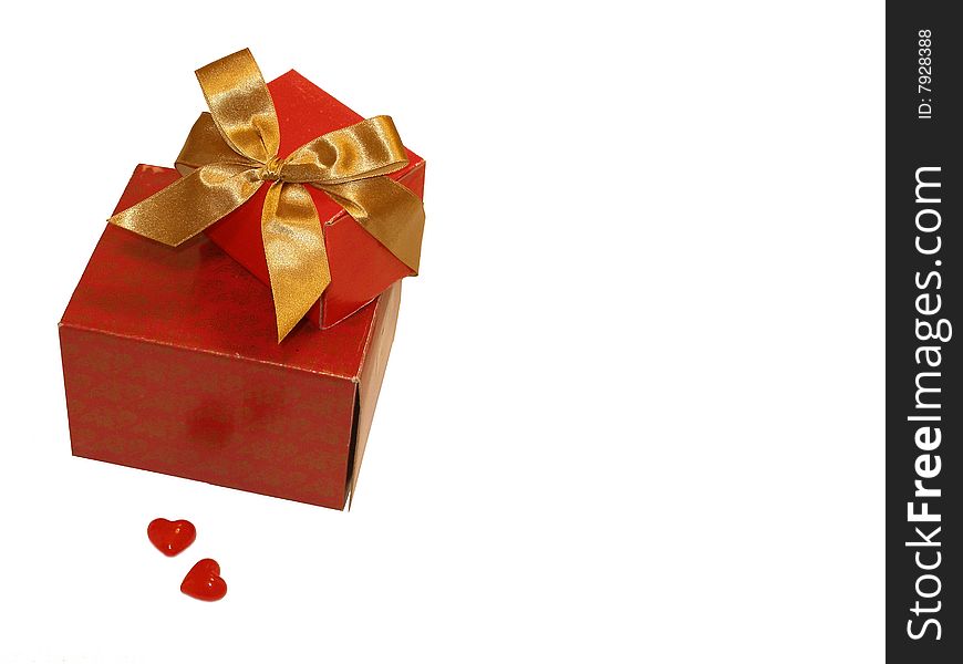 Two red gifts with a gold ribbon and two hearts