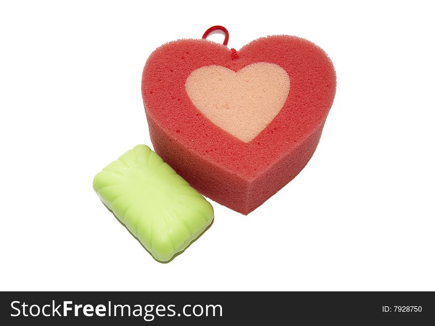 Photo of a sponge in the form of heart with soap on a white background. Photo of a sponge in the form of heart with soap on a white background.