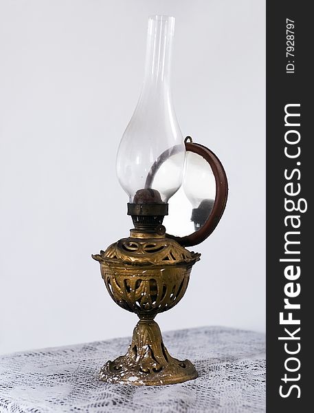 An old oil lamp laying on the table