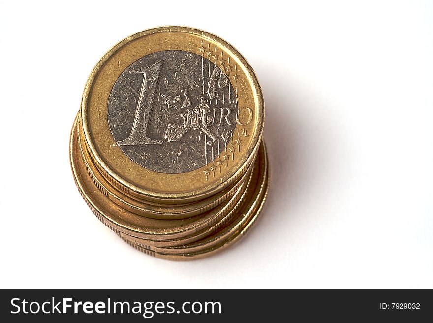 A pile of one euro coins isolated on a white background. A pile of one euro coins isolated on a white background